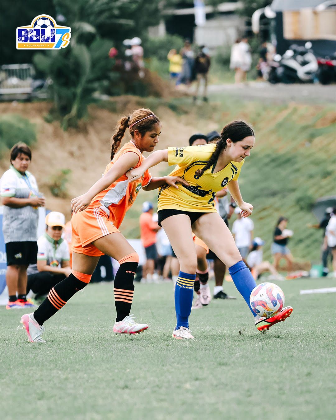 Two girls competing for the ball at BALI7s